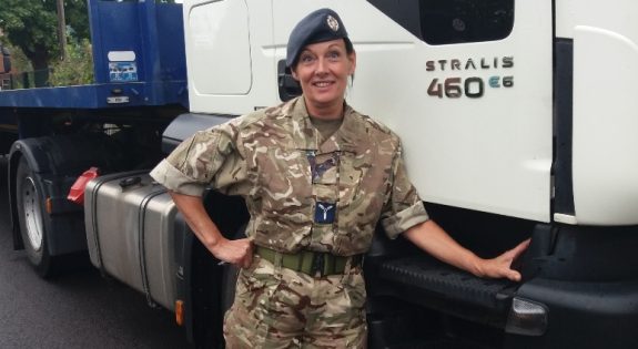 Dawn Lucas-Lickess poses in her uniform in front of a lorry