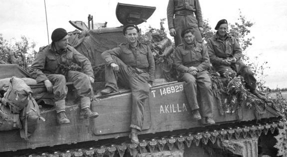 Army personnel sitting on tank