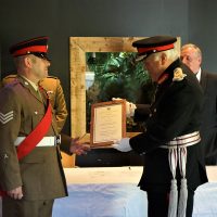 Sergeant Grant being presented with his certificate by the Lord Lieutenant