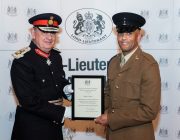 One man receiving a certificate from another.