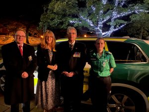 Representatives of Lincolnshire ACF with representatives of St Johns Ambulance with an emergency vehicleshire, holding an oversized cheque for ABF The Soldiers Charity