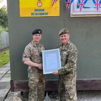 Cadet Staff Sergeant William Craft receiving his Commendation from Colonel Ian Sackree.