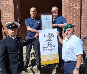 Members of Bassetlaw District Council holding the Armed Forces Covenant logo.