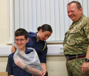 Flight Sergeant Lyra Smith applies first aid to a fellow Cadet, helped by Richard Halford (father of Ben Halford), the Squadron Adjutant
