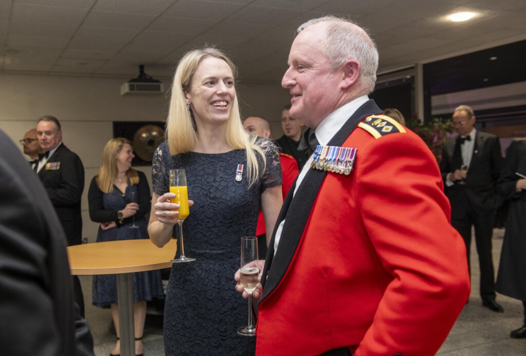 Louise Sandher-Jones, Minister for Veterans and People, smiling while networking with guests at the Gold Employer Recognition Scheme Awards ceremony.